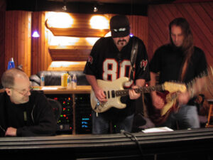 Photo of Tom Morris recording dueling guitar solos from members of the Outlaws