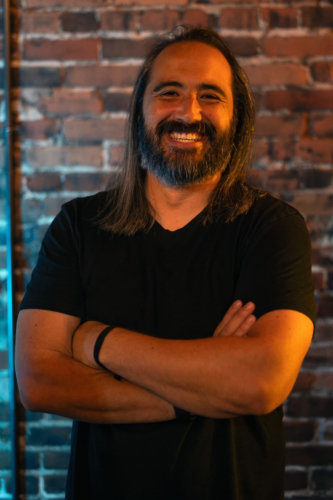 BJ Ramone in front of a brick wall